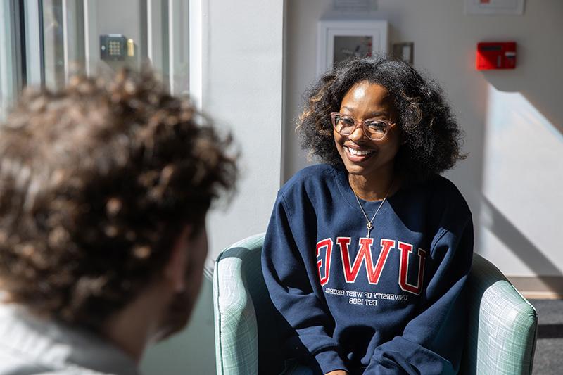 female student seated in conference room